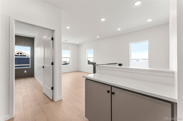 corridor with light hardwood / wood-style flooring