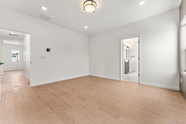 unfurnished room with light hardwood / wood-style flooring