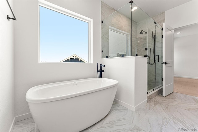 bathroom featuring a healthy amount of sunlight and plus walk in shower