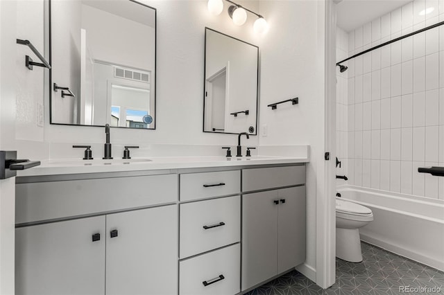 full bathroom with toilet, vanity, tiled shower / bath, and tile patterned flooring