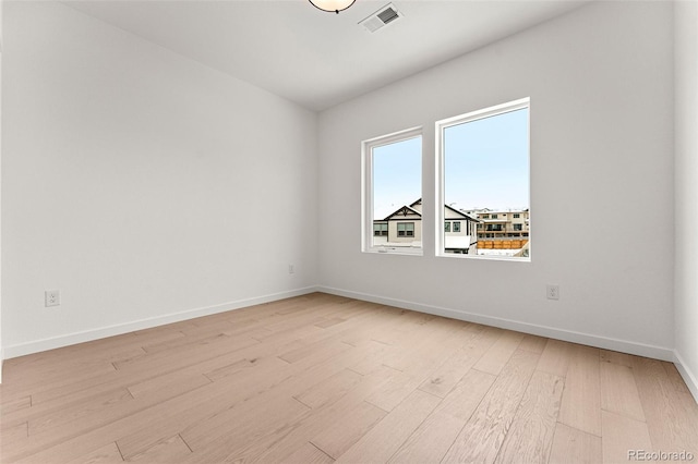 spare room with light hardwood / wood-style flooring