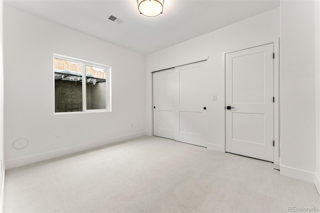 unfurnished bedroom featuring light colored carpet