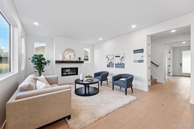 972 Arapahoe Cir, Louisville, CO 80027 - living room with stairs, baseboards, light wood-type flooring, recessed lighting, and a tiled fireplace