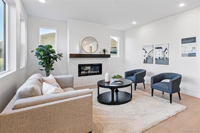 972 Arapahoe Cir, Louisville, CO 80027 - living area featuring recessed lighting, plenty of natural light, wood finished floors, and a tile fireplace