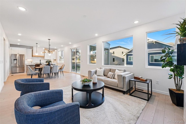 972 Arapahoe Cir, Louisville, CO 80027 - living area featuring an inviting chandelier, baseboards, recessed lighting, and light wood-style flooring