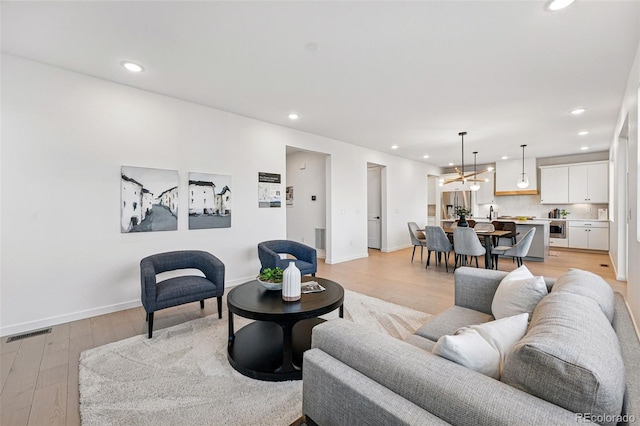 972 Arapahoe Cir, Louisville, CO 80027 - living area with visible vents, an inviting chandelier, baseboards, light wood-type flooring, and recessed lighting