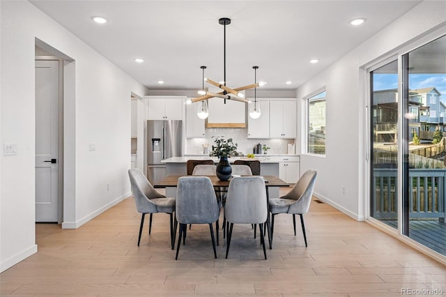 972 Arapahoe Cir, Louisville, CO 80027 - dining space with recessed lighting, baseboards, an inviting chandelier, and light wood-type flooring