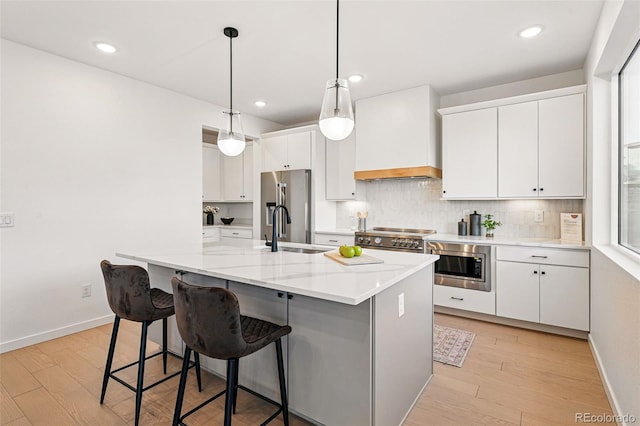 972 Arapahoe Cir, Louisville, CO 80027 - kitchen featuring a sink, appliances with stainless steel finishes, white cabinets, and light wood-type flooring