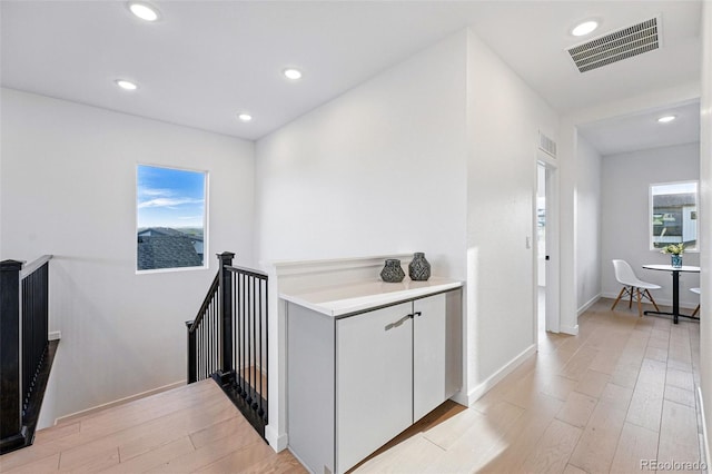972 Arapahoe Cir, Louisville, CO 80027 - hall with visible vents, recessed lighting, light wood finished floors, and an upstairs landing