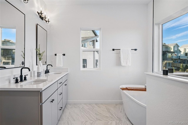 972 Arapahoe Cir, Louisville, CO 80027 - full bathroom with double vanity, a sink, marble finish floor, and a freestanding bath