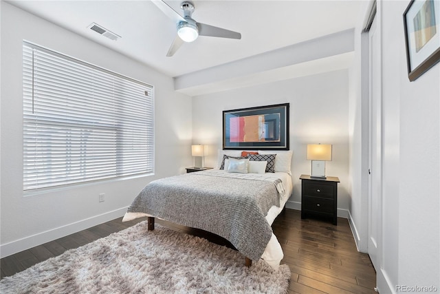 bedroom featuring ceiling fan, dark wood-type flooring, and a closet