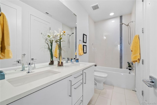 full bathroom with tile patterned flooring, vanity, toilet, and tiled shower / bath