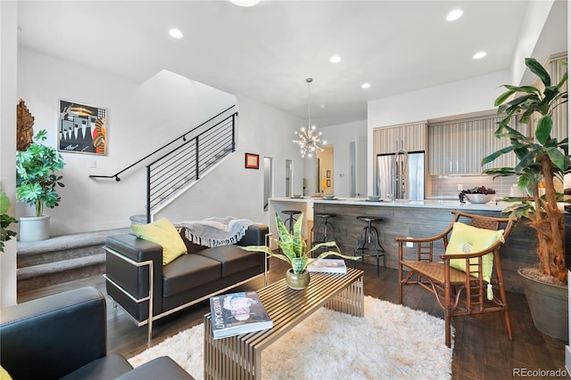 living room with a chandelier and dark wood-type flooring