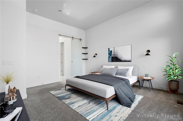 bedroom with carpet and a barn door