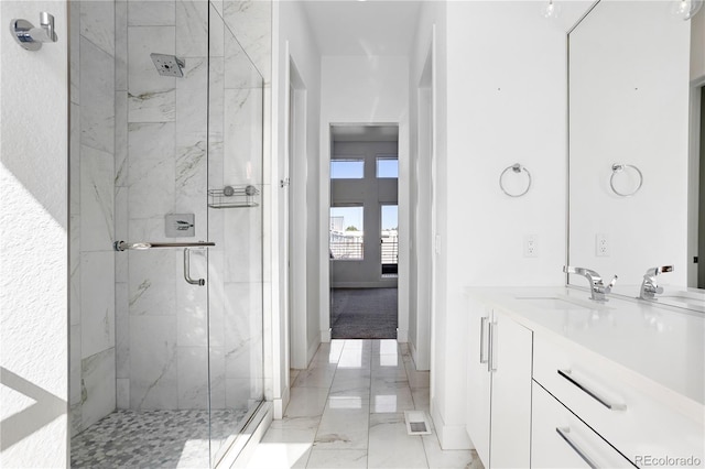 bathroom featuring vanity and an enclosed shower