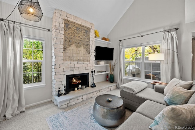 carpeted living room with high vaulted ceiling, a wealth of natural light, and a fireplace