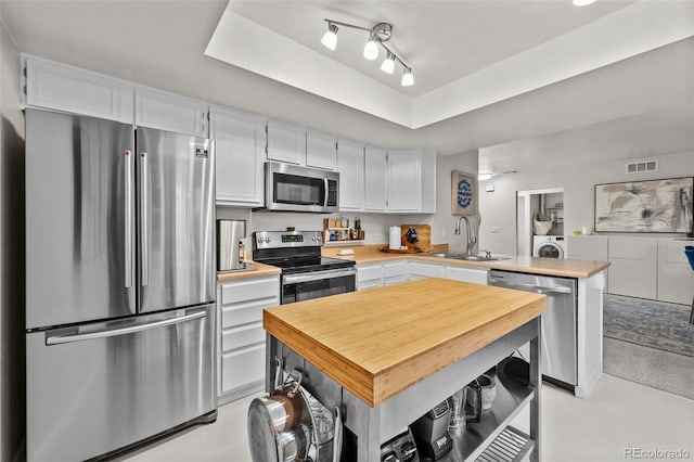 kitchen with white cabinets, sink, and stainless steel appliances