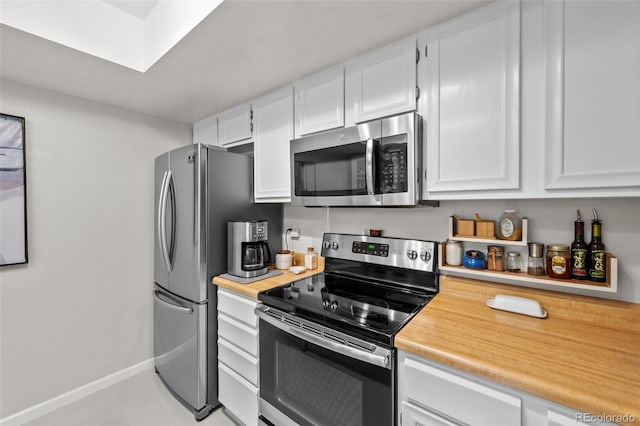 kitchen featuring white cabinets and appliances with stainless steel finishes