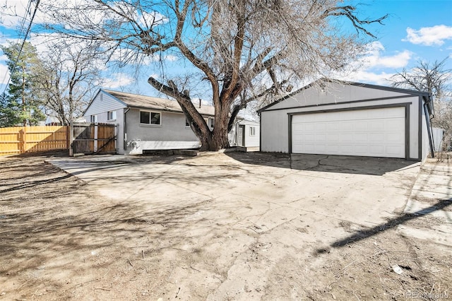 exterior space with a garage, fence, and an outdoor structure