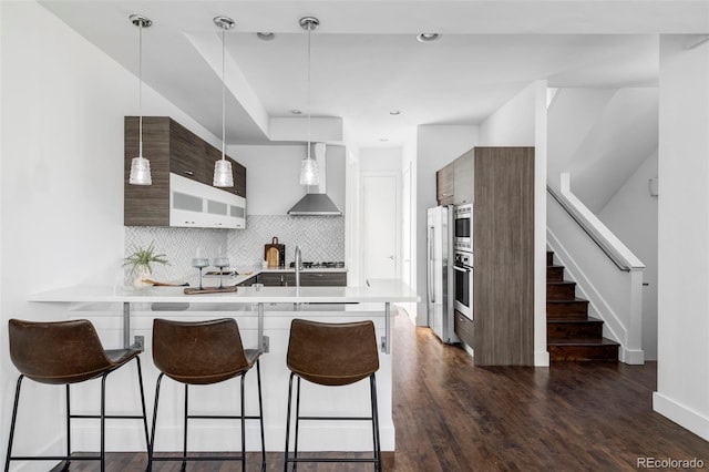 1715 Boulder St, Denver, CO 80211 - kitchen with wall chimney exhaust hood, modern cabinets, a breakfast bar, a peninsula, and recessed lighting