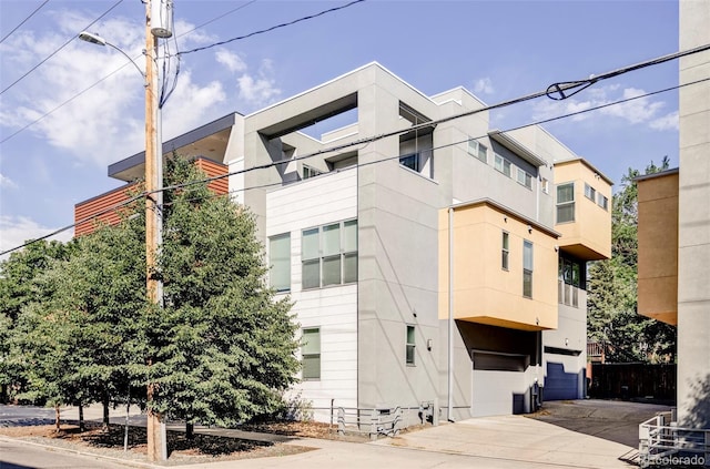 1715 Boulder St, Denver, CO 80211 - view of building exterior with an attached garage and concrete driveway