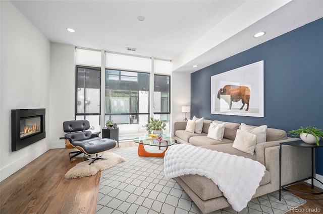 living room with hardwood / wood-style flooring and expansive windows