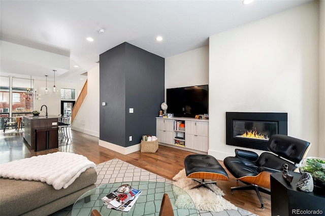 living room with hardwood / wood-style flooring and sink