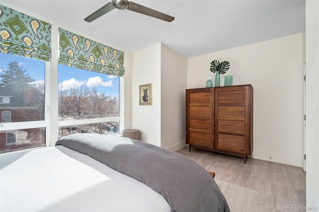 bedroom with ceiling fan and light wood-type flooring