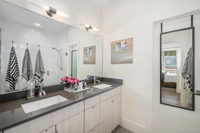 bathroom with a shower with door and vanity