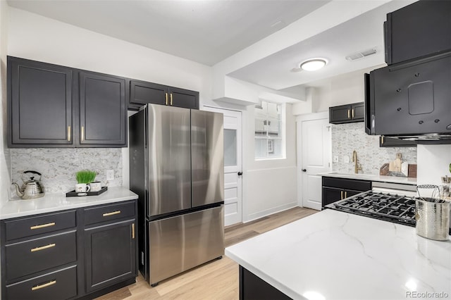 1019 26th St, Denver, CO 80205 - kitchen featuring freestanding refrigerator, a sink, light wood-style flooring, and decorative backsplash