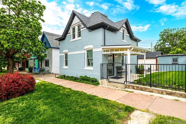 1019 26th St, Denver, CO 80205 - view of front of house with covered porch and brick siding