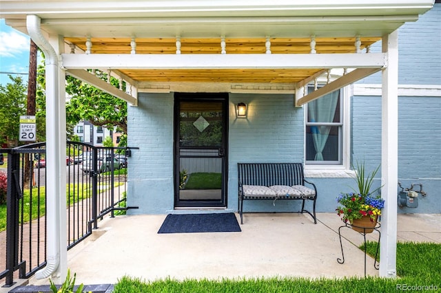 1019 26th St, Denver, CO 80205 - view of exterior entry featuring brick siding and a porch