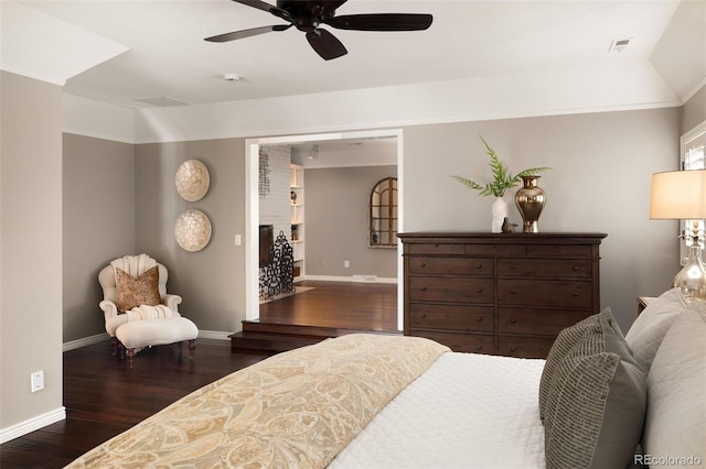 bedroom with dark hardwood / wood-style floors and ceiling fan