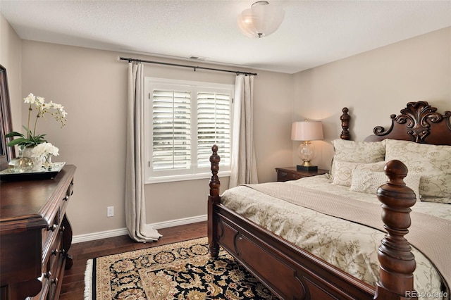 bedroom featuring dark hardwood / wood-style floors and a textured ceiling