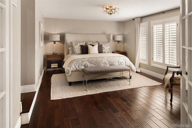 bedroom with dark hardwood / wood-style flooring