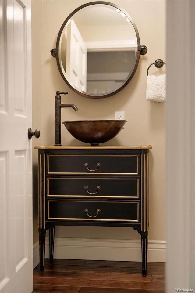 interior details featuring vanity and hardwood / wood-style floors