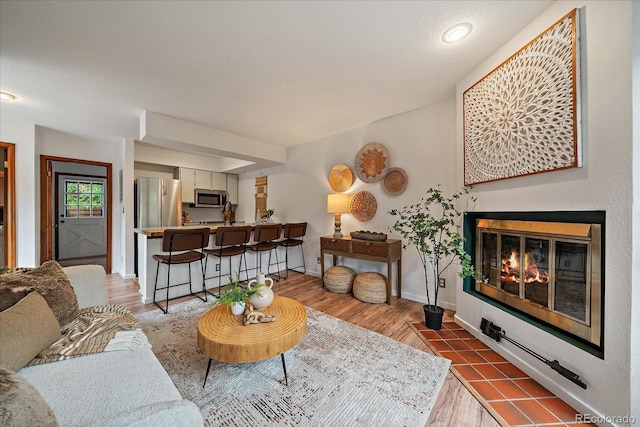 2429 Spruce St Unit 4, Boulder, CO 80302 - living area featuring wood finished floors and a fireplace with flush hearth