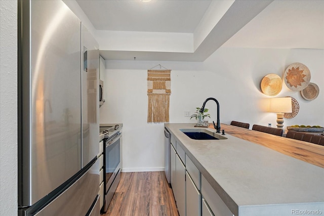 2429 Spruce St Unit 4, Boulder, CO 80302 - kitchen with appliances with stainless steel finishes, a peninsula, dark wood-style flooring, light countertops, and open floor plan