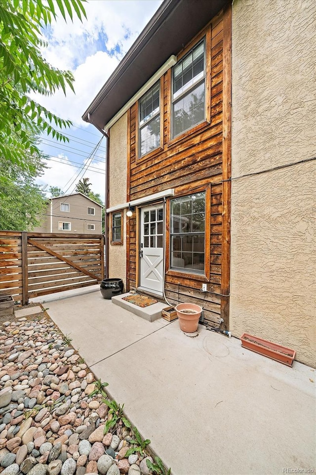 2429 Spruce St Unit 4, Boulder, CO 80302 - rear view of property with a gate, stucco siding, and a patio