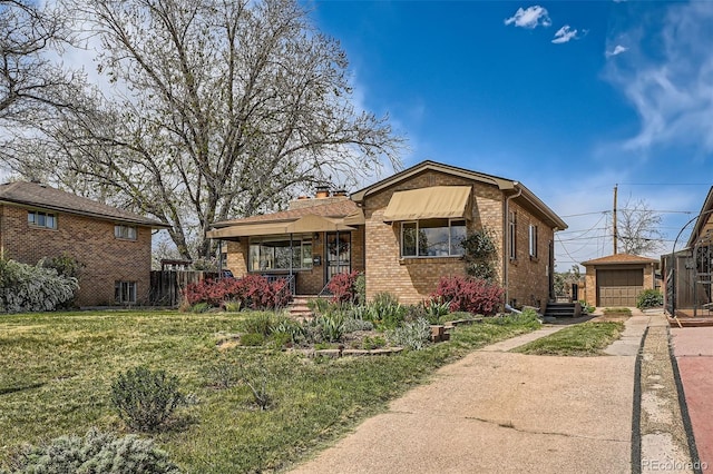 bungalow-style house featuring a porch, an outbuilding, brick siding, a front lawn, and concrete driveway