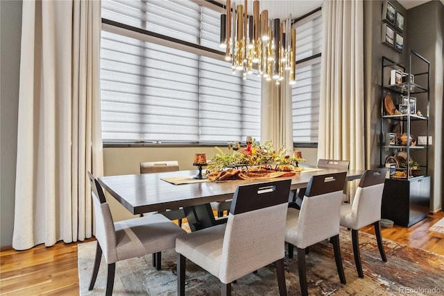 dining area featuring a notable chandelier and wood finished floors