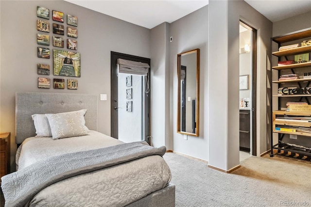 carpeted bedroom featuring baseboards