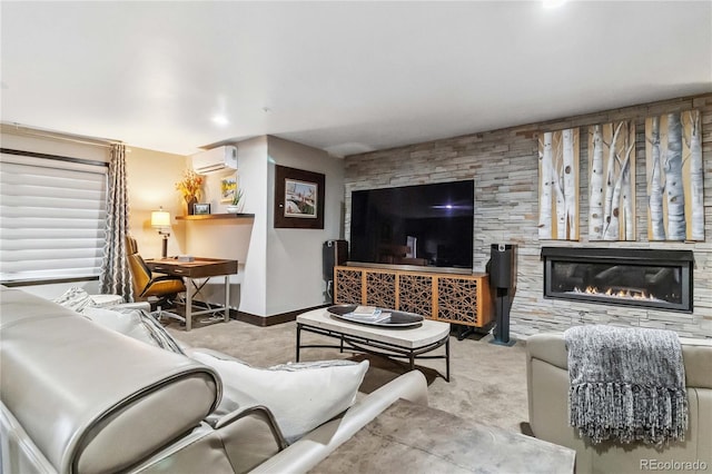 carpeted living room with a glass covered fireplace, baseboards, and a wall mounted air conditioner