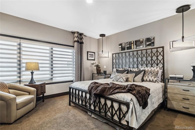 bedroom with baseboards and carpet flooring