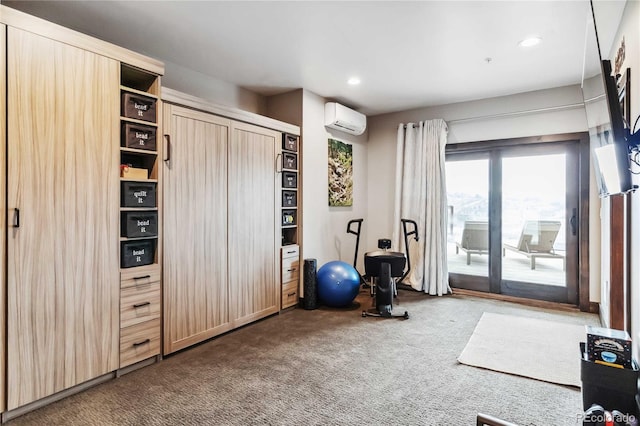 exercise area featuring an AC wall unit, recessed lighting, and carpet