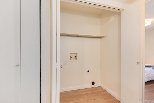 8335 Fairmount Dr Unit 7-208, Denver, CO 80247 - laundry room featuring hookup for an electric dryer, hookup for a washing machine, light wood-style flooring, and baseboards