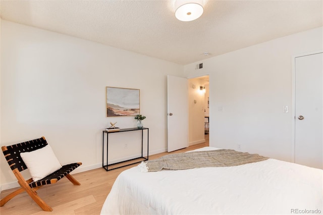 8335 Fairmount Dr Unit 7-208, Denver, CO 80247 - bedroom featuring light wood-style flooring and baseboards