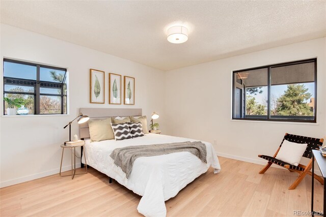 8335 Fairmount Dr Unit 7-208, Denver, CO 80247 - bedroom with multiple windows and light wood-type flooring