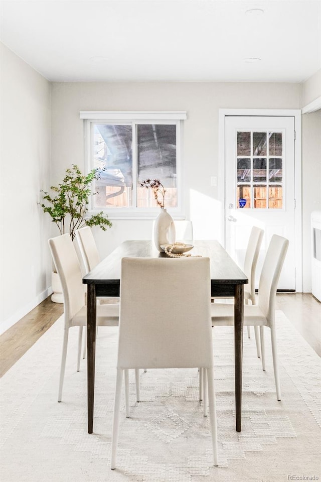 dining space with light hardwood / wood-style floors