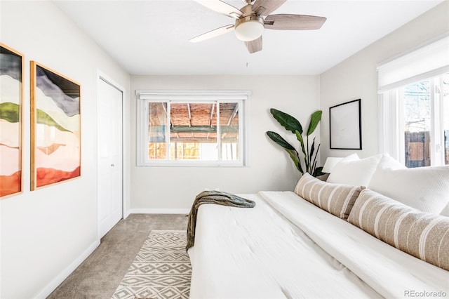 bedroom featuring light carpet, a closet, and ceiling fan